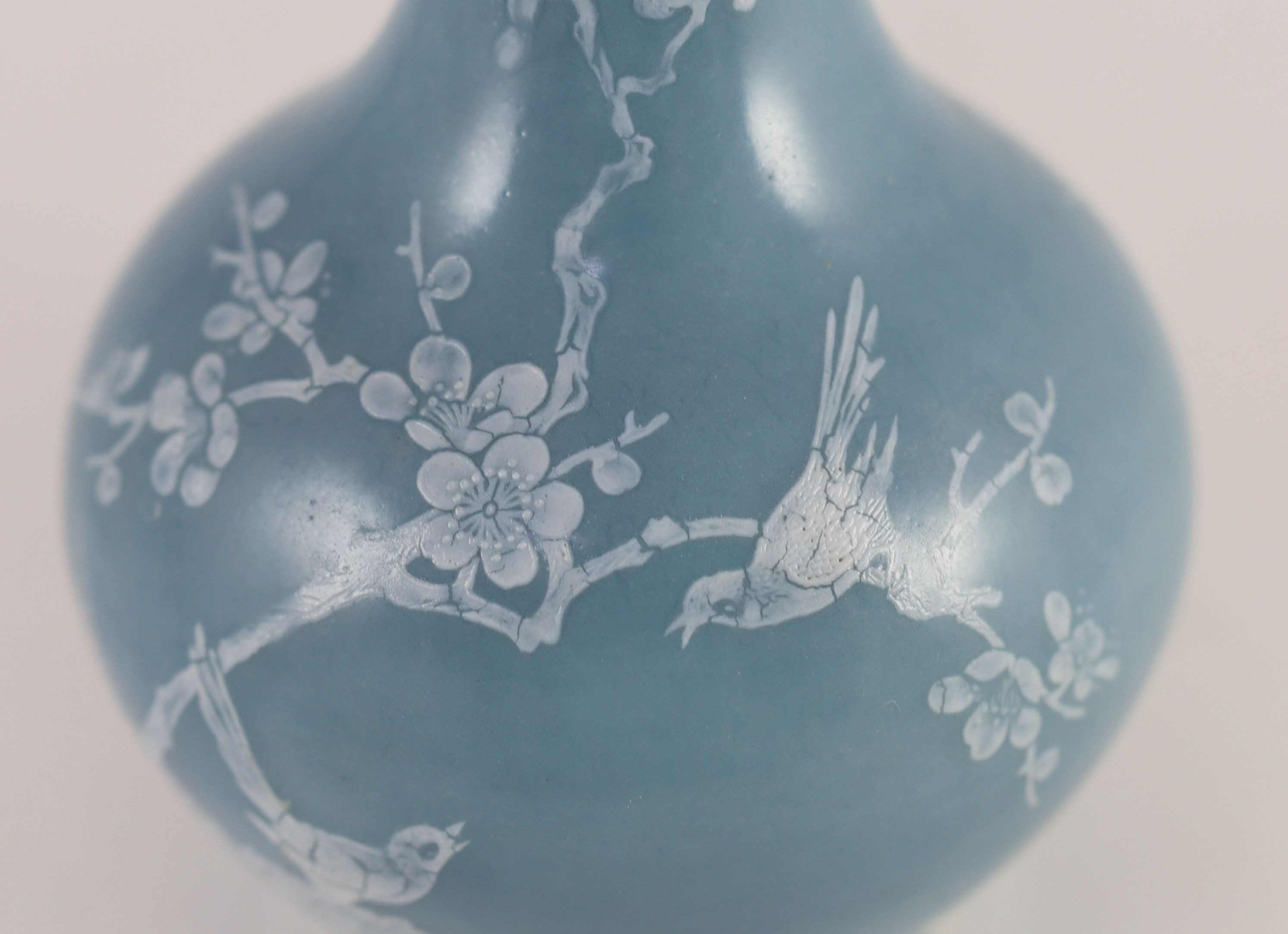 A Chinese claire de lune glazed white slip decorated vase - 25cm high